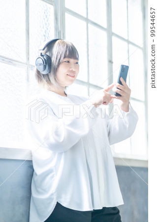 Body positive woman enjoying music subscription Body positive woman enjoying music subscription 99544657
