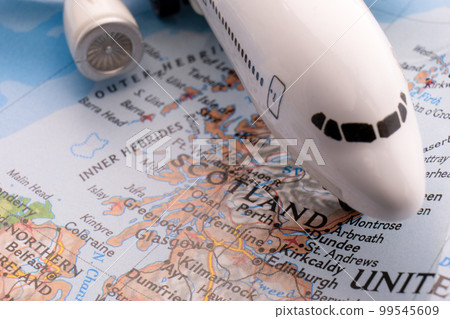 Close up of a miniature passenger plane on a colorful map highlighting Edinburgh, Dundee through selective focus, background blur. High quality photo Close up of a miniature passenger plane on a colorful map highlighting Edinburgh, Dundee through selective focus, background blur. High quality photo 99545609