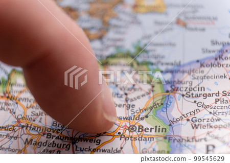 Close up of finger pointing to Berlin, Germany on colorful map with selective focus, shallow depth of field, background blur. High quality photo Close up of finger pointing to Berlin, Germany on colorful map with selective focus, shallow depth of field, background blur. High quality photo 99545629