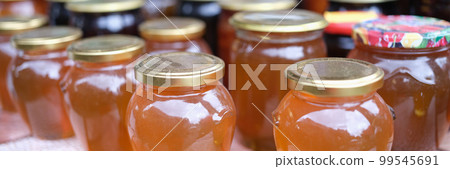 Lot of homemade apple juice in jars closeup Lot of homemade apple juice in jars closeup 99545691