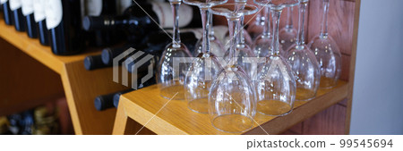 Bottles of wine wine glasses on cabinet rack Bottles of wine wine glasses on cabinet rack 99545694
