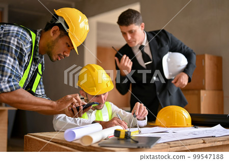 A professional Asian male construction inspector using scientific calculator. A professional Asian male construction inspector using scientific calculator. 99547188