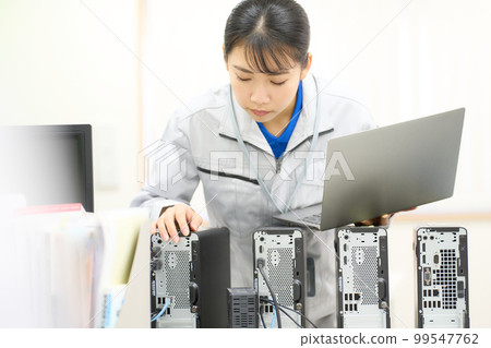 Information system staff checking the lined up PCs Information system business image 99547762