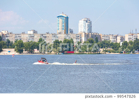 Summer river landscape with motorboat and water skiing. Summer river landscape with motorboat and water skiing. 99547826