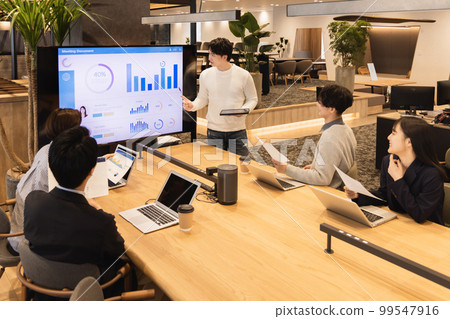 Men and women having a meeting using a monitor Men and women having a meeting using a monitor 99547916