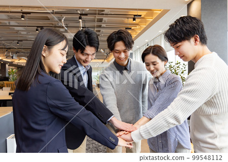 A circle of people working in a fashionable designer's office 99548112