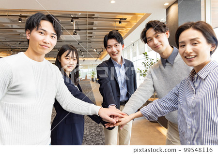 A circle of people working in a fashionable designer's office A circle of people working in a fashionable designer's office 99548116
