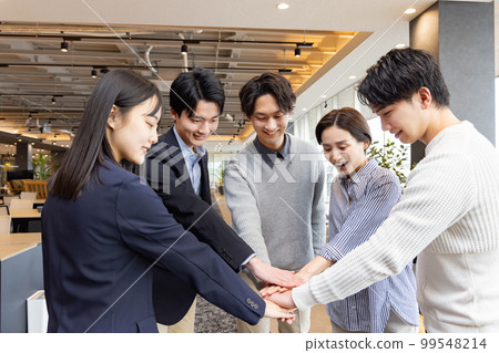 A circle of people working in a fashionable designer's office 99548214