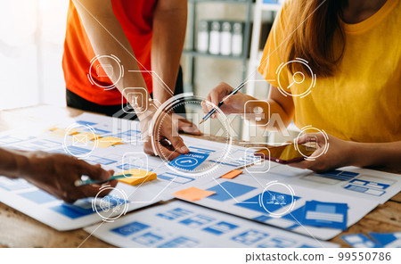 UX developer and ui designer brainstorming about mobile app interface wireframe design with customer breif and color code at modern office.. 99550786