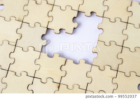 Missing heart-shaped puzzles. A background of puzzles with a white empty space. Missing heart-shaped puzzles. A background of puzzles with a white empty space. 99552037