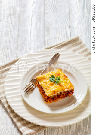 Greek Pastitsio on white plate, top view 99552196