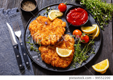 fried breaded chicken breast cutlets on plate 99552200