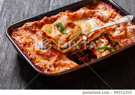 portion of Lasagna in baking dish, top view 99552203