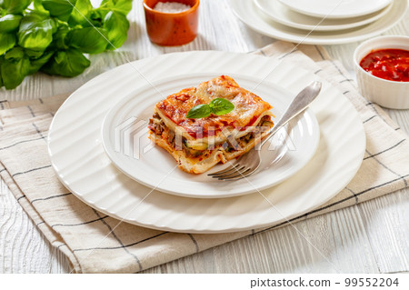 portion of Lasagna on white plate, top view portion of Lasagna on white plate, top view 99552204