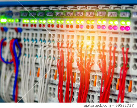Network cables connected to switch. Many multi-colored wires connected to digital hub. Background Network cables connected to switch. Many multi-colored wires connected to digital hub. Background 99552737