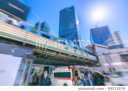 The cityscape of Tokyo, Japan: An ambulance dispatched in front of Shibuya Station. Paramedics heading to the requested location The cityscape of Tokyo, Japan: An ambulance dispatched in front of Shibuya Station. Paramedics heading to the requested location 99553839