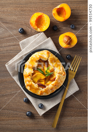 Fruit galette, composition for tasty food concept, top view Fruit galette, composition for tasty food concept, top view 99554730