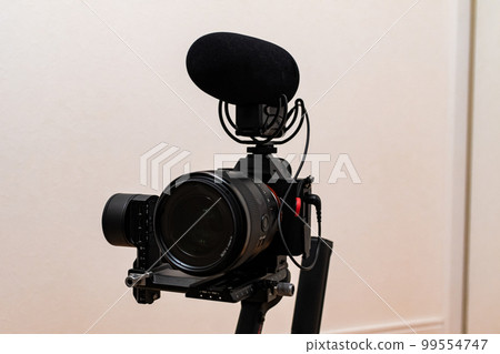 Attach a camera and microphone to the gimbal and shoot video 99554747