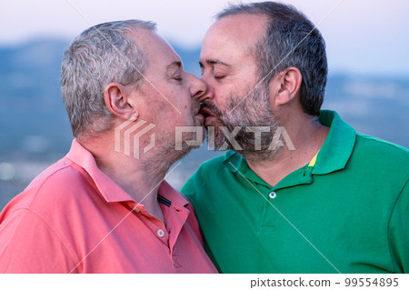 Mature men kissing with closed eyes Mature men kissing with closed eyes 99554895