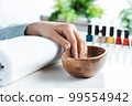 Closeup female hands in wooden bowl with water 99554942