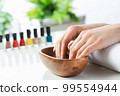 Woman hands in wooden bowl with water 99554944