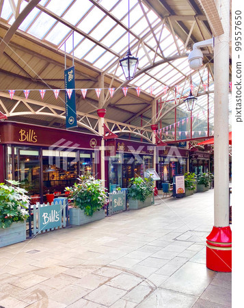 An interior view of an arch lined with shops at Windsor Royal Station in the city of Windsor Castle in England 99557650