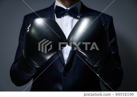 Businessman in boxing gloves on gray background 99558190