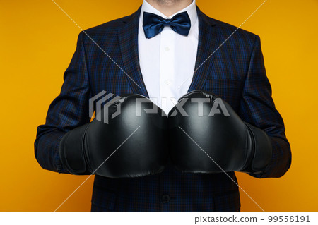 Businessman in boxing gloves on yellow background 99558191