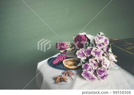 Green background, dried flowers and accessories Green background, dried flowers and accessories 99558308
