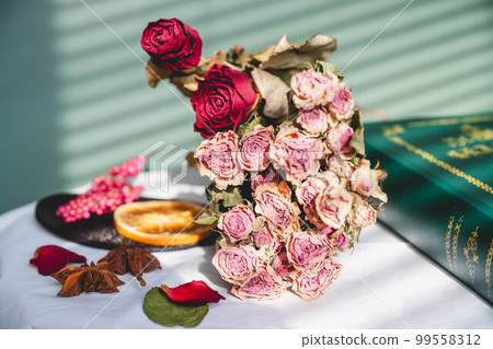 Green background, dried flowers and accessories 99558312