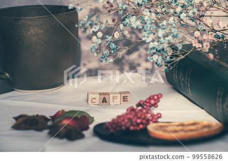 Blind shadows, coffee cups and dried flowers Blind shadows, coffee cups and dried flowers 99558626