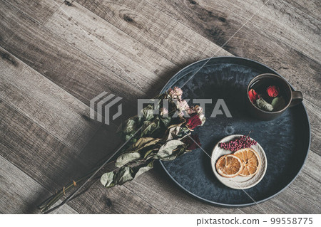 Coffee cup with wood background and flower petals Coffee cup with wood background and flower petals 99558775