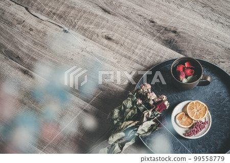 Coffee cup with wood background and flower petals Coffee cup with wood background and flower petals 99558779