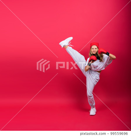 Little girl wearing red boxing gloves, studio shot, sport concept 99559696