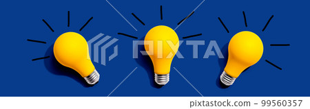 Three yellow light bulbs 99560357