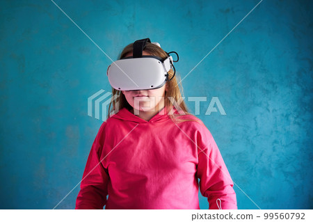 little girl playing with VR glasses 99560792