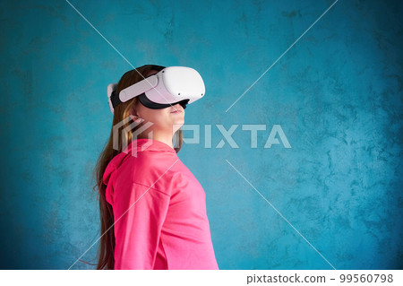 little girl playing with VR glasses 99560798