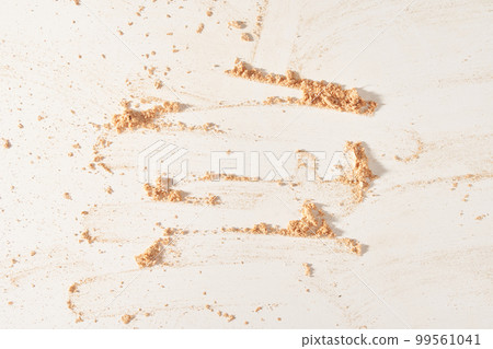 A neutral-colored face powder smeared on the surface, on a light background. Top view, flat position. Copy the location for your text. Powder texture. High quality photo A neutral-colored face powder smeared on the surface, on a light background. Top view, flat position. Copy the location for your text. Powder texture. High quality photo 99561041