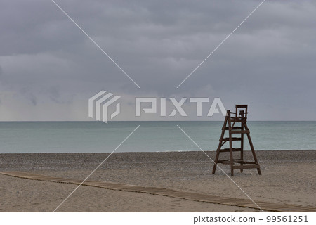 A wooden lifeguard chair on lonely beach A wooden lifeguard chair on lonely beach 99561251