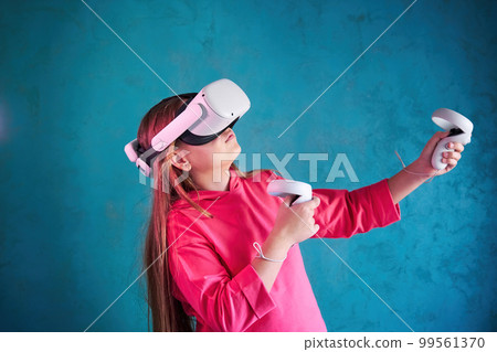 little girl playing with VR glasses 99561370