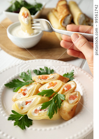 Concept of tasty food, thin pancakes with filling 99561742