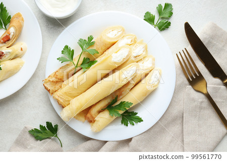 Concept of tasty food, thin pancakes with filling, top view Concept of tasty food, thin pancakes with filling, top view 99561770