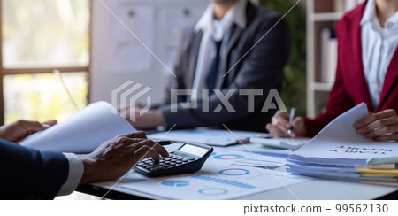 Team of business investment consultant analyzing company annual financial report working with documents pie and donut chart, using laptop, Business and Financial concept 99562130