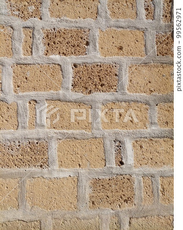 Fragment of a shell rock wall. Masonry and brick, tile and stone. An old wall of a shell rock. Naples, Italy Fragment of a shell rock wall. Masonry and brick, tile and stone. An old wall of a shell rock. Naples, Italy 99562971