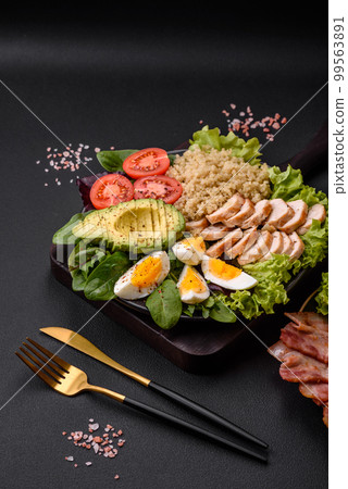 Delicious healthy lunch consisting of chicken, avocado, quinoa, eggs and tomatoes 99563891