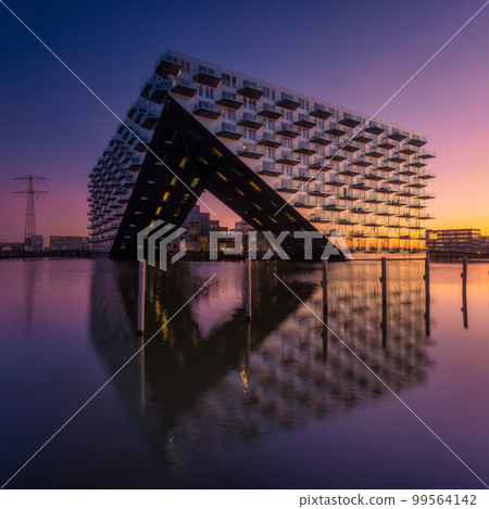 Amsterdam, Netherlands. A cityscape during sunset. Architecture of the Netherlands. Amsterdam, Netherlands. A cityscape during sunset. Architecture of the Netherlands. 99564142