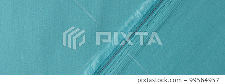 Light blue fabric with fringe and seam closeup Light blue fabric with fringe and seam closeup 99564957