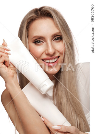 Beautiful blond girl with a perfectly hair, and classic make-up with cosmetic products. Beauty face and hair. Beautiful blond girl with a perfectly hair, and classic make-up with cosmetic products. Beauty face and hair. 99565760