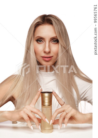 Beautiful blond girl with a perfectly hair, and classic make-up with cosmetic products. Beauty face and hair. Beautiful blond girl with a perfectly hair, and classic make-up with cosmetic products. Beauty face and hair. 99565761