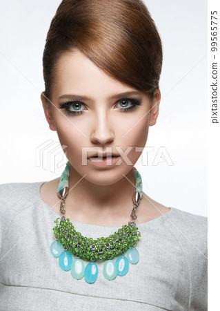 Beautiful fashionable girl with smooth hair and original decoration around her neck. Model in white. Beauty face. Beautiful fashionable girl with smooth hair and original decoration around her neck. Model in white. Beauty face. 99565775